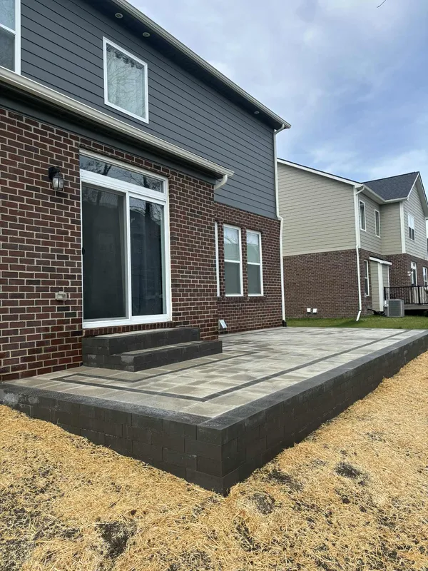 Large back patio with paver steps