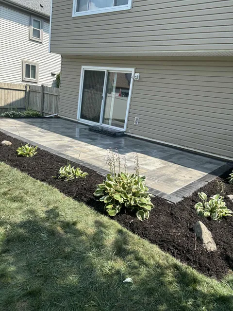 Back patio installation with garden beds