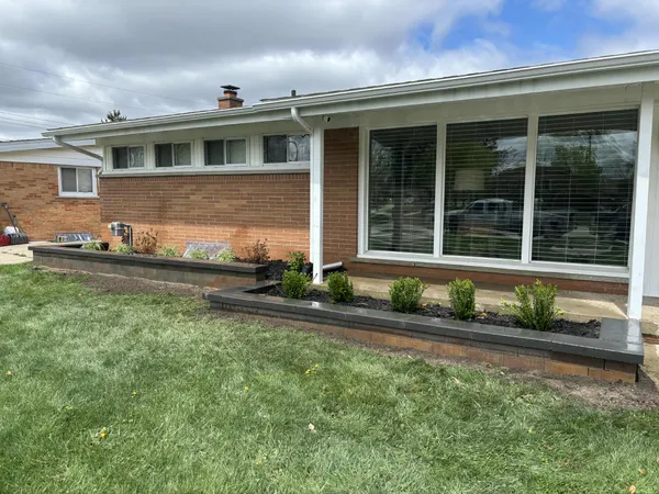 Fresh landscape installation with retaining wall and new plantings