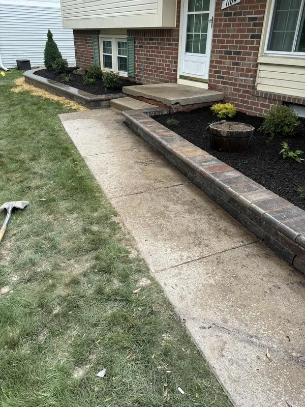 Retaining wall border and garden bed installation along house